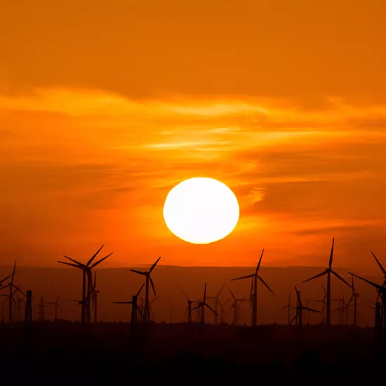 Sunset with wind turbines in the foreground