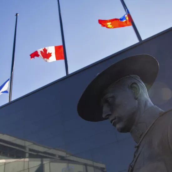 Flags of Nova Scotia and Canada fly at half-staff outside the Nova Scotia Royal Canadian Mounted Police (RCMP) headquarters in Dartmouth, Nova Scotia, Canada, on April 19, 2020