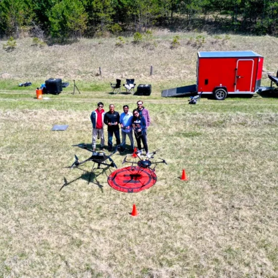 Group photo of researchers in a clearing with drone equipment