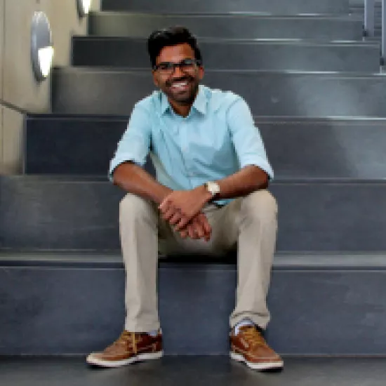 Daniel Jayasinghe sits on the stairs