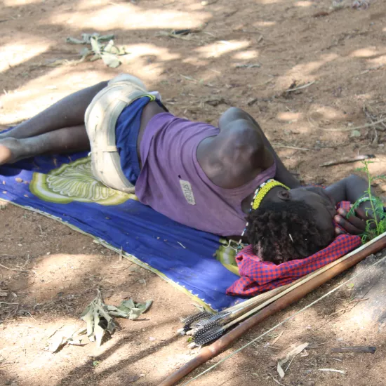 Hadza man sleeping on ground