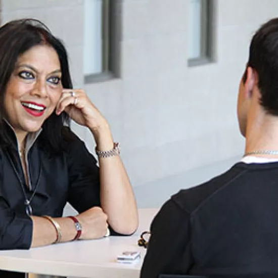 Mira Nair speaks to attendee at event