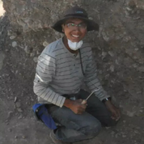 Jeremy Rimando excavates an earthen pit in Argentina