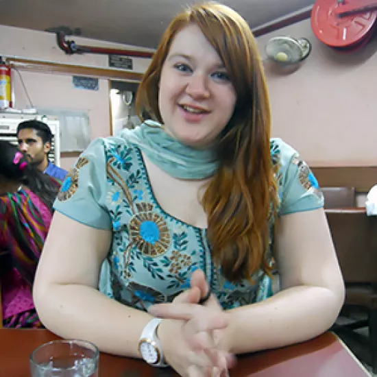 Kristin Plys in a coffeeshop in India, wearing a sari