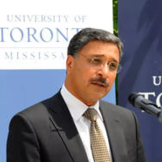 Photo of Professor Deep Saini in front of the microphone, speaking at the podium