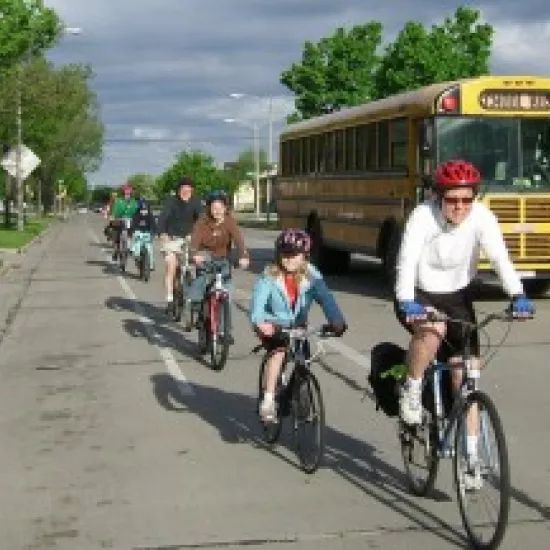 kids on bikes next to a yellow school bus