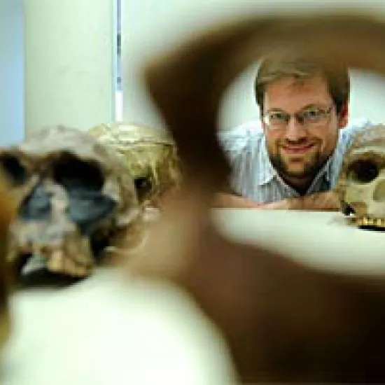 Man and human skulls