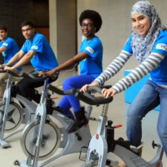 four students on an excercise bike