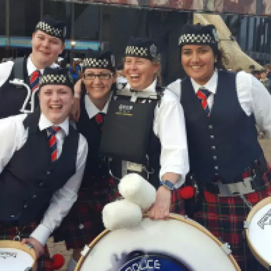 group of women in Scottish dress with drums
