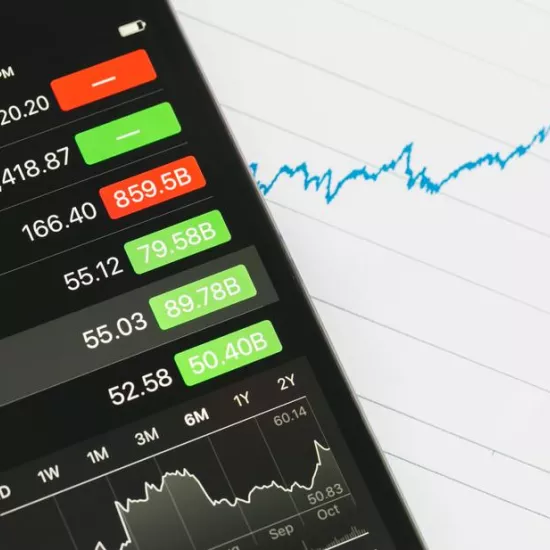 smartphone with stock prices and graph in blue ink