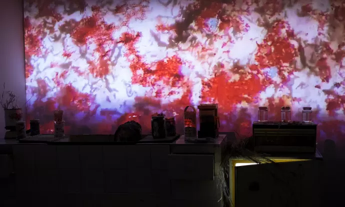 A red dappled pattern being projected on the way of a recreated kitchen