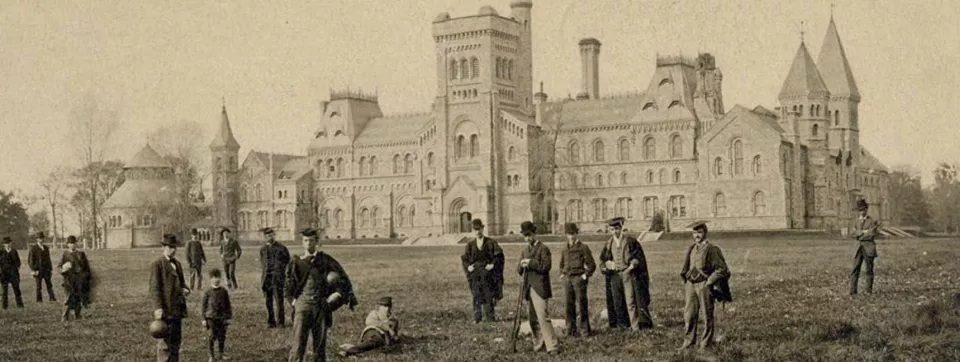 Old photo of people standing on grass in front of University College