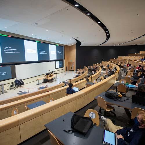 U of T lecture hall with masked students and instructor
