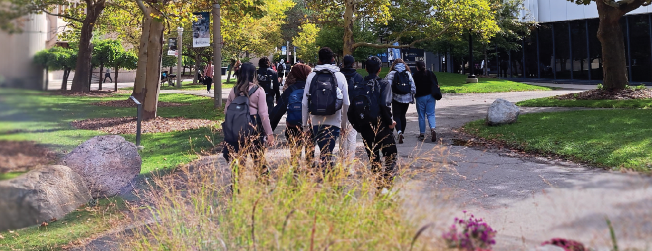 Photo of students walking on campus near the Innovation Complex