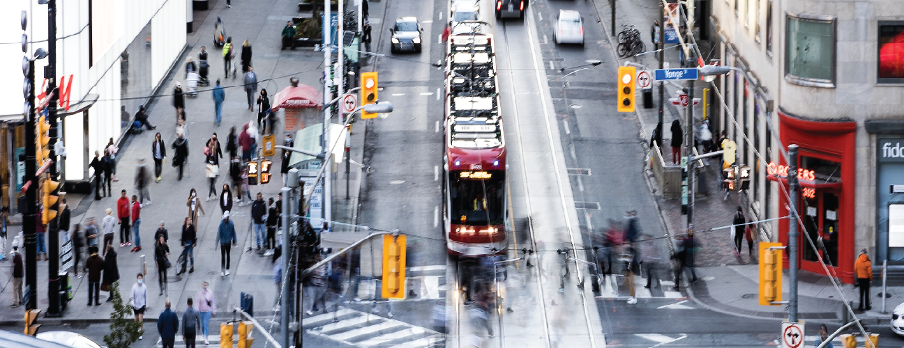 TTC streetcar at an intersection with pedestrians all around