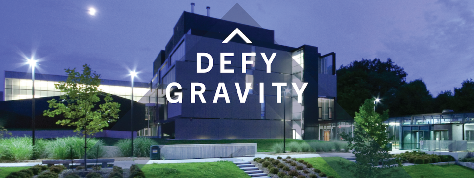Photo of CCT at night with the Defy Gravity logo