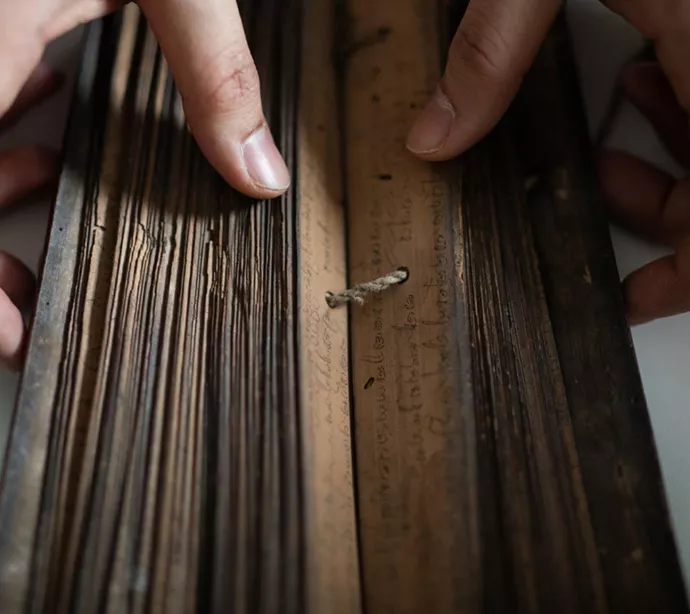 String holds together the leaves of a palm leaf manuscript