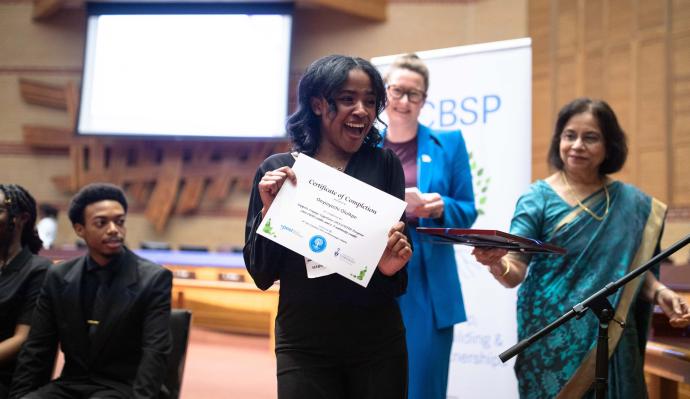 SEE UTM graduate Onyinyechi Oluikpe shows off her certificate during the Support, Engage, Experience University of Toronto Mississauga program's celebration and graduation event 