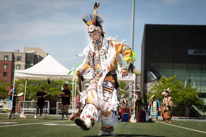 Indigenous dancer at the vaccine clinic pow wow at U of T's Varsity Stadium