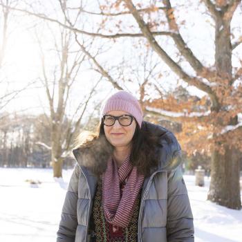 Alexandra Gillespie standing outside on the UTM campus, surrounded by snow