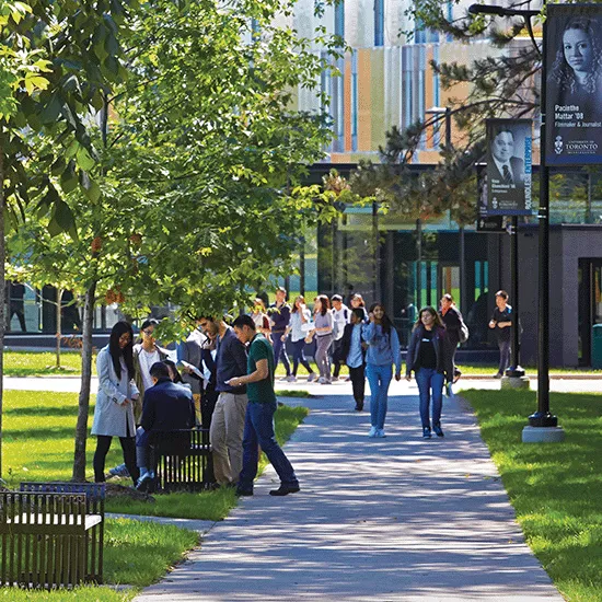 Students and faculty wander the UTM campus on a summer day