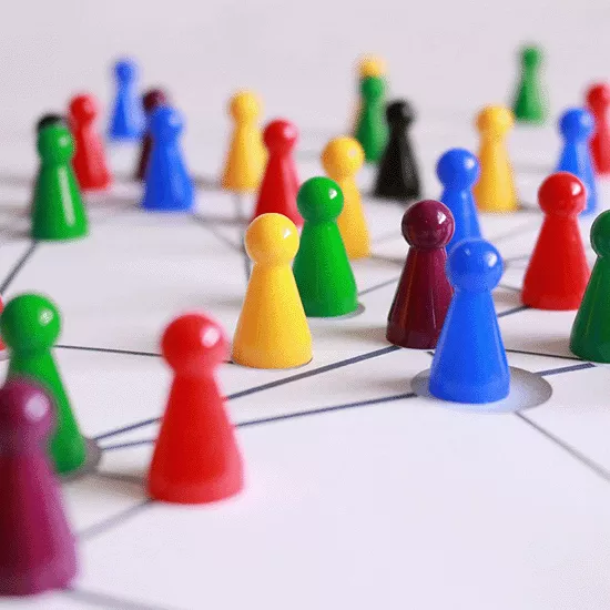 Colourful game pieces being set up on a board
