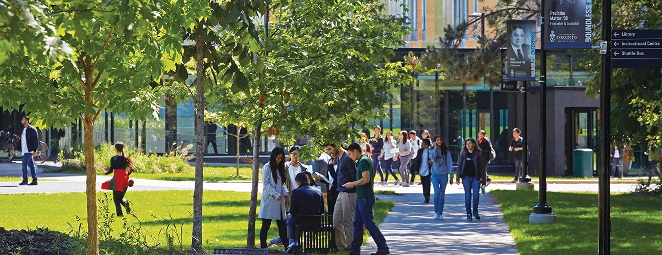 Students and faculty wander the UTM campus on a summer day