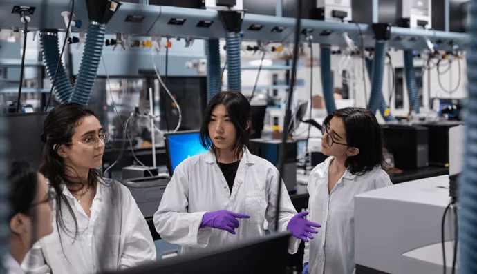 A group of female students chatting in a lab